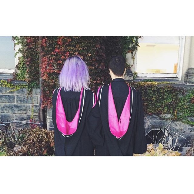 Image of two graduands in their academic regalia
